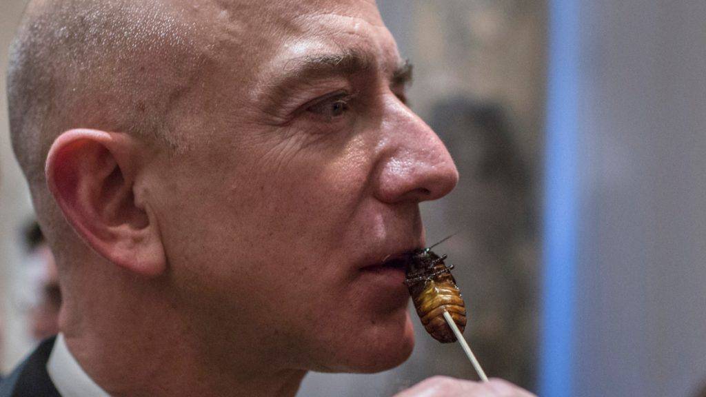 Close-up of Amazon founder, Jeff Bezos, holding a cockroach skewered on a kabob stick to his mouth.