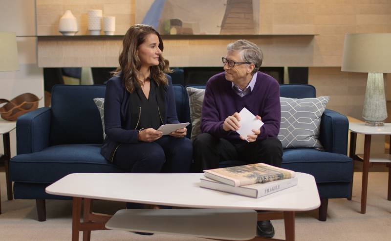 Bill and Melinda Gates sitting together on a couch.